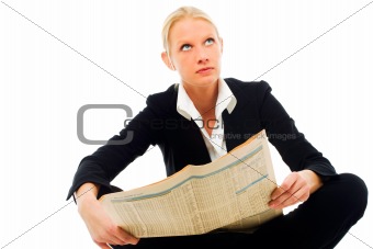 portrait of a young caucasian woman wearing a black jacket sitting down and reading a newspaper looking for work
