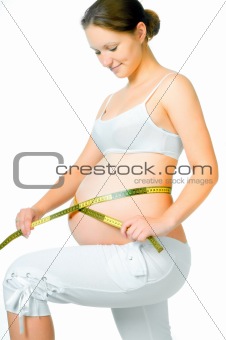pregnant woman measuring belly