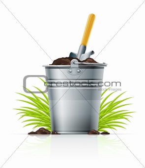 metallic bucket with ground and shovel