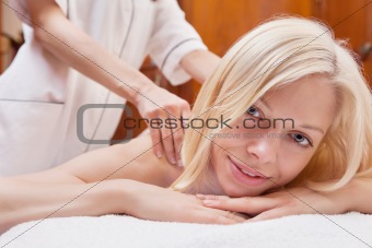 Blond woman having a massage in a spa