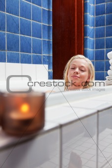 Beautiful young woman in bathtub with eyes closed