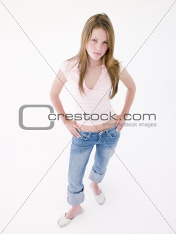 Teenage girl with hands on hips frowning