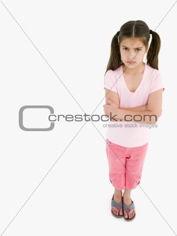Young girl with arms crossed angry