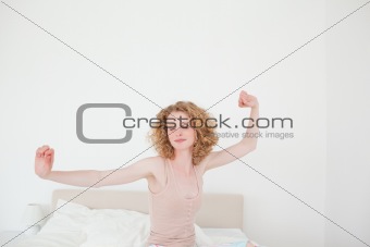 Gorgeous blonde female stretching in her bedroom
