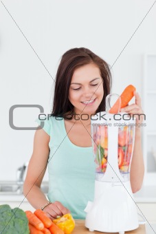 Cute woman using a blender