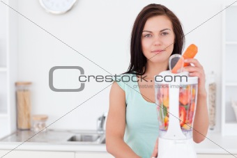 Beautiful woman using a blender