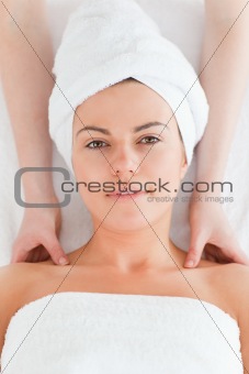 Delighted brunette enjoying a shoulder massage