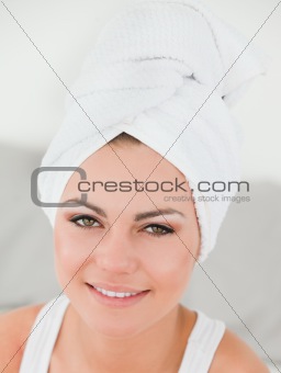 Close up of a woman with the hair wrapped into a towel