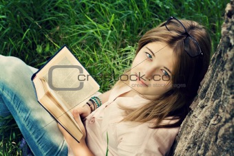 Teenages girl reading book