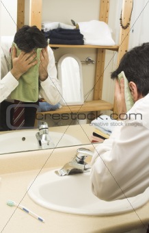 man drying face with towel