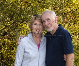 Loving senior couple embracing outdoors