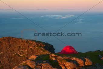 Tent on a Mountain Ridge Lit by the Midnight Sun