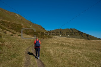 Hiker on a mountain pasture