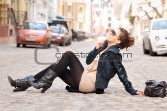 fashionable girl sitting on the street