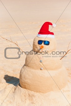 Snowman Built As Sandcastle On Beach