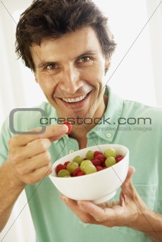 Mid Adult Man Eating Fresh Fruit