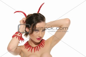 Sexy woman with jewelry and horns of red hot pepper