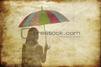 Girl with umbrella at sea coast. Photo in old image style.