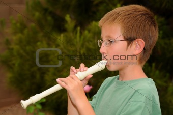 Boy playing a recorder