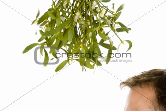Man waiting under bunch of mistletoe