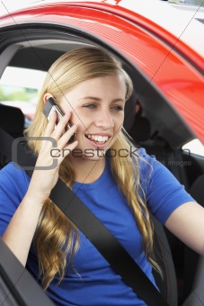 Teenage Girl Sitting In Car Talking On Cellphone