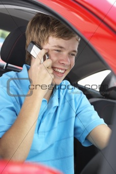Teenage Boy Sitting In Car, Talking On Cellphone