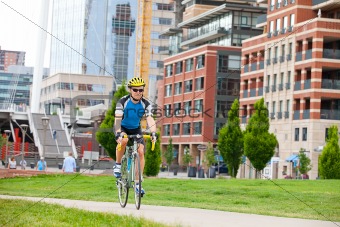 Male bike rider in city park