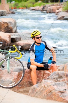 Cyclist sitting by the river