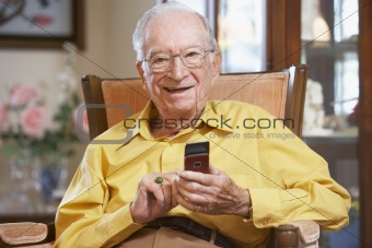 Senior man text messaging