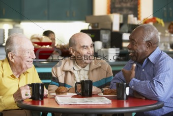 Senior men drinking tea together