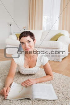 Portrait of a cute brunette with a magazine