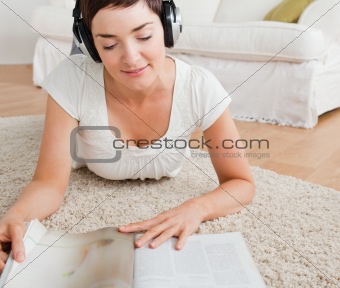 Woman reading a magazine while enjoying some music
