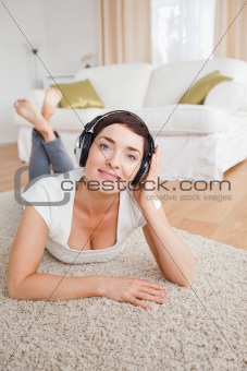 Portrait of a smiling brunette listening to music