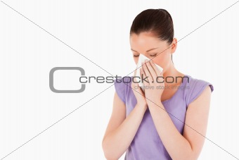 Good looking woman sneezing while standing