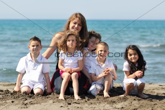 group portrait of childrens with teacher on beach