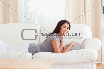 young woman lying on sofa