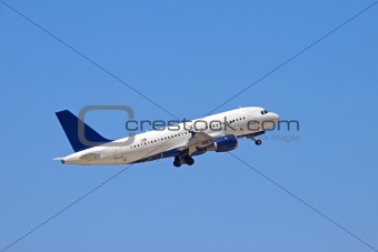 A jet plane flying into a blue sky.