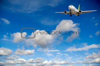 Air travel - Plane flying in blue sky with clouds