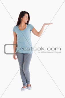 Beautiful woman showing a copy space while standing