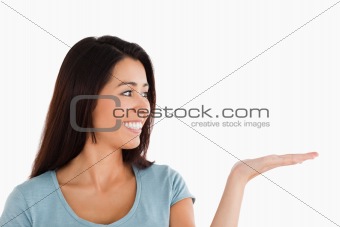 Portrait of a gorgeous woman showing a copy space while standing