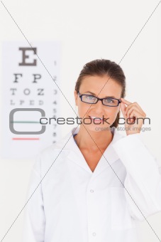 Eye specialist wearing glasses looking into the camera