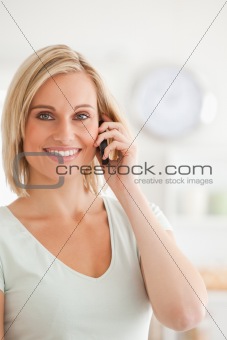 Close up of a charming woman on mobile looking into the camera