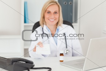 Smiling doctor holding prescription