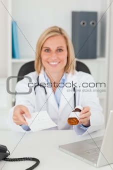 Smiling blonde doctor holding prescription and medicine looks in