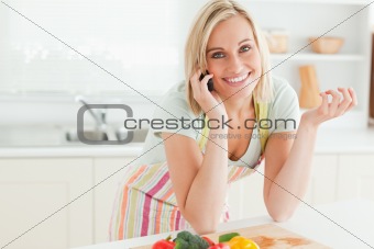 Close up of a gorgeous woman on phone looking into camera