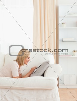 Portrait of a charming woman using a tablet computer