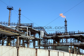 torch is lit on tower refinery