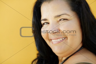 mature hispanic woman smiling at camera