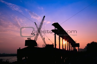 Cranes working at sunset