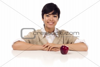 Smiling Mixed Race Young Adult Female Sitting at White Table with Apple Isolated on a White Background.